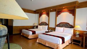 a hotel room with two beds and a lamp at The Golf Lodge Hotel Laem Chabang Golf in Ban Nong Wa +19 photos