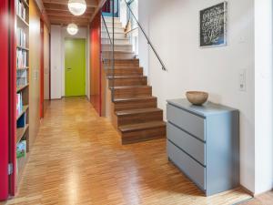 a hallway with stairs and a blue dresser at Waldnahes Ferienhaus in Freital in Freital +28 photos