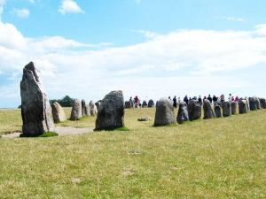 a group of people standing in a field with rock formations at 5 person holiday home in KLIPPAN-By Traum in Hagstad