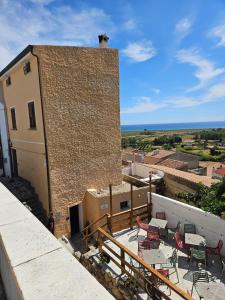 a building with tables and chairs on top of it at Sa meraviglia in Posada