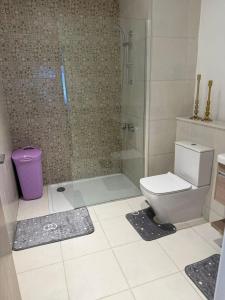 a bathroom with a toilet and a glass shower at Apartment at Marassi in El Alamein