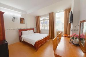 a bedroom with a bed and a television in it at TK Diamond Hotel - Saigon Center in Ho Chi Minh City