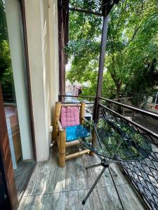 a balcony with a chair and a glass table at Boutique Hotel Point in Tbilisi City +27 photos