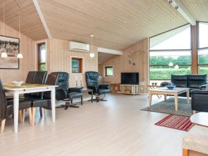 a living room with a table and chairs at 6 person holiday home in Ansager in Ansager
