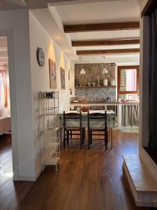 a kitchen and dining room with a table and chairs at the house in the village in Valentano