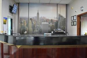 a bar with a large picture of a city at Atlantic Inn and Suites - Wall Township in Wall Township