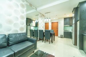 a living room with a couch and a dining room at 2BR Near Mall grand Indonesia Thamrin, SCBD in Jakarta