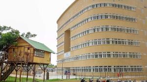 a large building with motorcycles parked in front of it at Bhartiya City 2 BHK Nikoo Living in Bengaluru