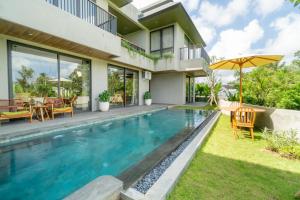 a swimming pool in the backyard of a house at Renjana Villas in Ubud