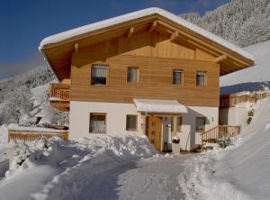 a house in the snow with a lot of snow around it at Pircherhof in San Candido