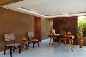 an office with a desk and chairs and a computer at Villa Tegal Tis Ubud in Payangan