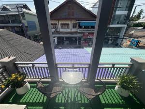 a balcony with chairs and a swimming pool at Lamai Beachroad Apartment in Lamai +3 photos