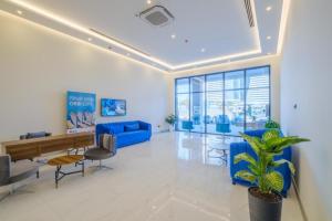 a living room with blue furniture and a blue couch at Batumi Bay Retreat in Batumi