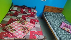 two twin beds in a room with sidx sidx sidx sidx at JK Homes in Kolli Hills