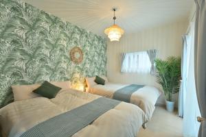 Giường trong phòng chung tại Otter Stay - Masaki