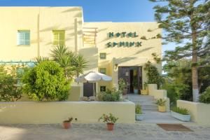 a building with an umbrella in front of it at Hotel Sphinx in Naxos Chora