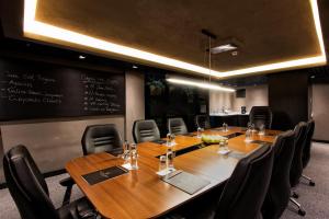 a conference room with a table and chairs and a chalkboard at Cityloft 81 in Istanbul