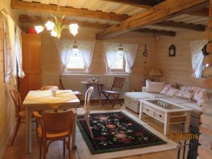 a living room with a couch and a table at Apartments Montana in Fužine