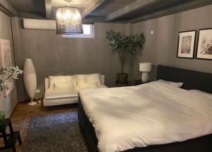 a bedroom with a large white bed and a couch at De Reesterhoeve in Balkbrug