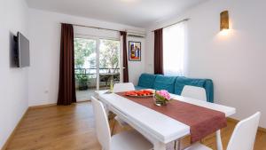 a dining room with a white table and chairs at Villa Sunj in Drače