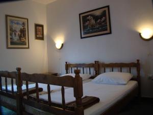 a bedroom with two beds and two pictures on the wall at Apartments Svorcan in Budva