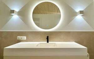 a bathroom with a white sink and a mirror at See I Jacuzzi I Balkon I Parkplatz I Bio Hof I TV in Rieden am Forggensee +24 photos