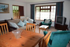 a living room with a couch and a table at Cosy Cottage in Sedgefield