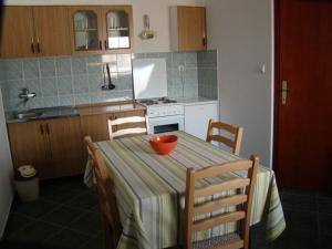 a kitchen with a table with a bowl on it at Apartments Svorcan in Budva