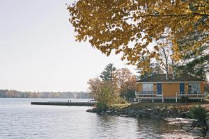 a small house on the shore of a lake at Bayview Wildwood Resort, an Ascend Collection Resort in Severn