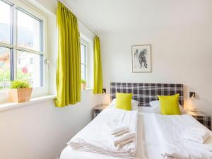 two beds in a room with green curtains at Chalet in Niedernsill near Ski Slopes in Niedernsill