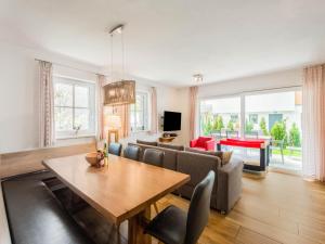 a living room with a table and a couch at Chalet in Niedernsill near Ski Slopes in Niedernsill