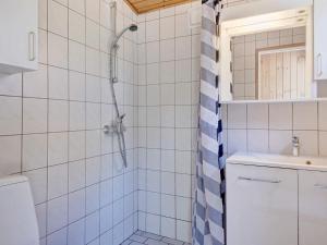 a bathroom with a shower and a sink at 4 person holiday home in Nexø in Neksø +12 photos