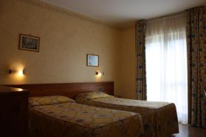 Postel nebo postele na pokoji v ubytování Hotel Beau Site