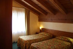 Postel nebo postele na pokoji v ubytování Hotel Beau Site