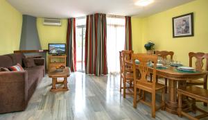 a living room with a table and a couch at Ona Campanario in La Cala de Mijas