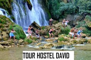 a group of people jumping into a waterfall at Hostel David in Mostar