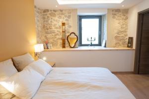 a bedroom with a white bed and a window at Le 214, Entre Lacs et Montagnes in Les Rousses