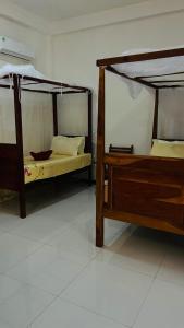 two bunk beds in a room with a white floor at Mahee house in Hiriketiya