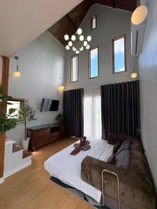 a bedroom with a large bed and a television at 549 Resort & Cafe Lamphun in Ban Mae Pok +108 photos