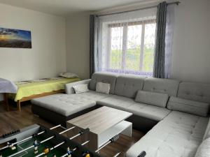 a living room with a couch and a table at Apartmán PASOMA in Levoča