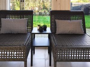 two wicker chairs and a table with a plant at Luxury Retreat in Pot Strandby - By Traum Ferienwohnungen in Sønderby