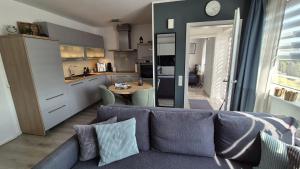 a living room with a couch and a kitchen at Ferienwohnung Villa Grimm in Burbach