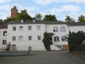 a large white building with a tower on top at Veltenhaus Historic Retreat in Mürlenbach