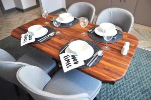 a wooden table with chairs and wine glasses on it at Tophane Suites in Istanbul
