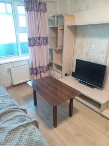 a living room with a coffee table and a tv at Apartment in Ulaanbaatar, Next to Narantuul Market, ,Mongolia in Ulaanbaatar