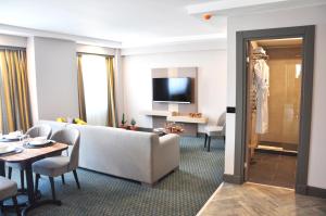 a living room with a couch and a table at Tophane Suites in Istanbul