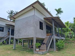 a house with a staircase in front of it at Bantai Hideaway - House 1 in Baan Tai