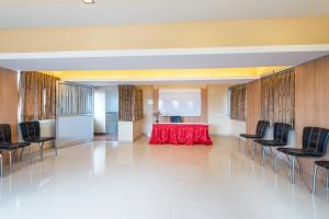 a conference room with a red table and chairs at Treebo Trend ESS Grande in Coimbatore