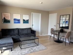 a living room with a couch and a table at New Aptartment Ocean View Central in Tromsø
