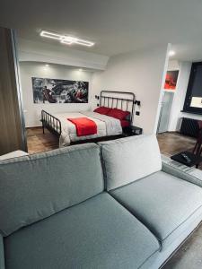 a bedroom with a bed and a couch in front of it at Legend Loft in Pont-Saint-Martin